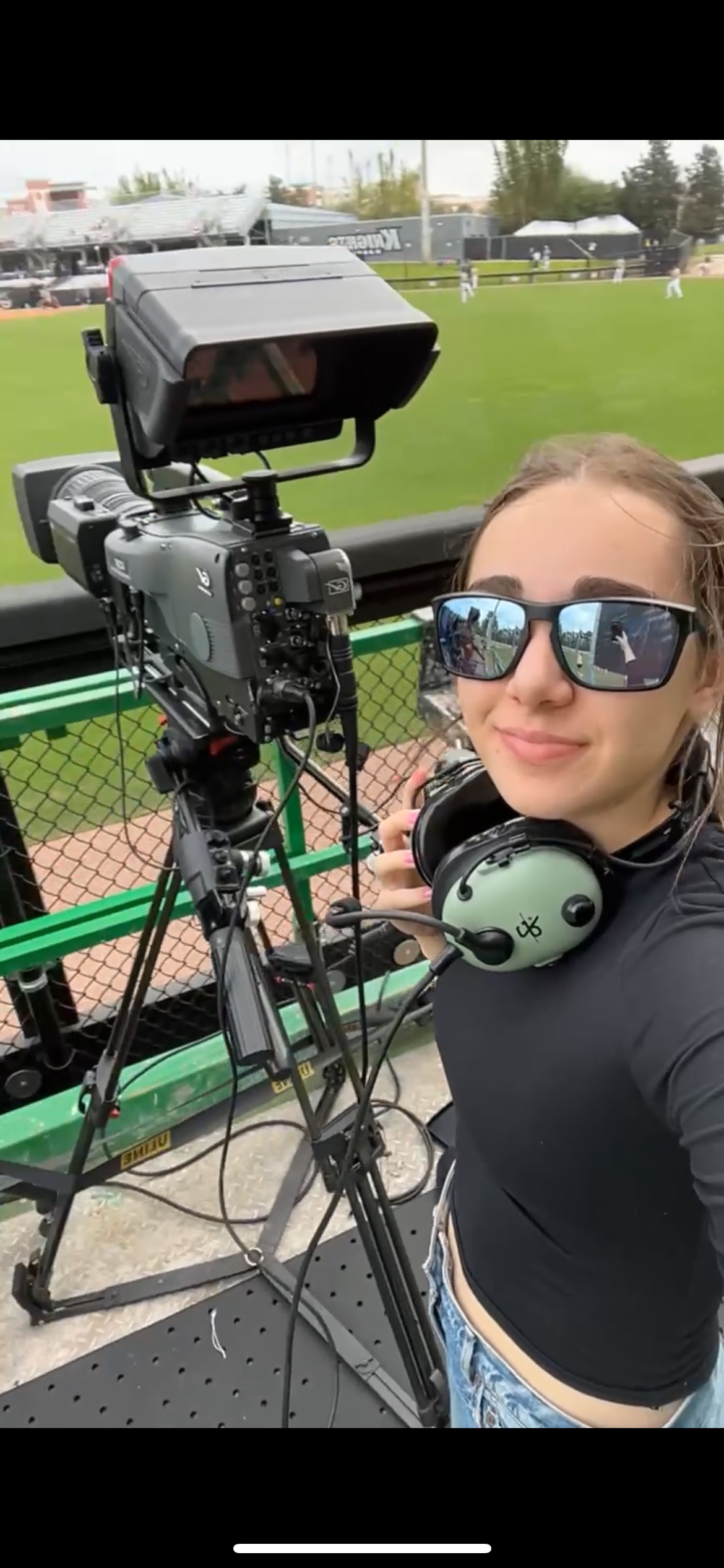 Julia Weinstein filming at a baseball stadium